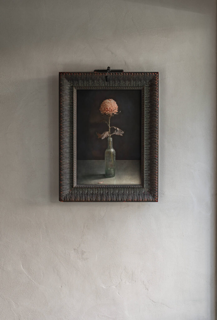 A hand-troweled textured clay plaster wall beautifully complementing artwork in a Central Texas home.