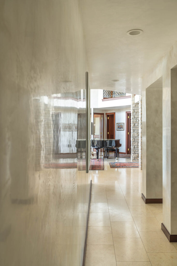 Custom hand troweled highly polished Marmorino plaster on hallway walls and ceiling in a Westlake Austin luxury home.